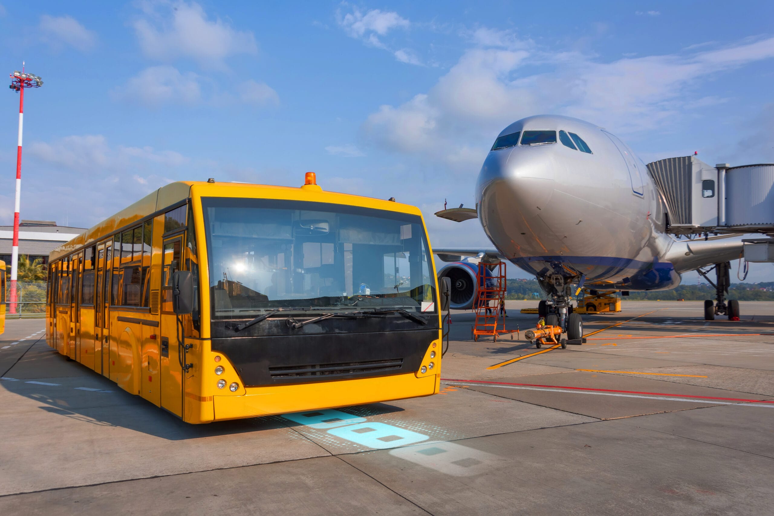Shuttle yellow bus waiting for passengers on the plane for transportation to the airport terminal. Aircraft arrival background. Travel tourist destination concept